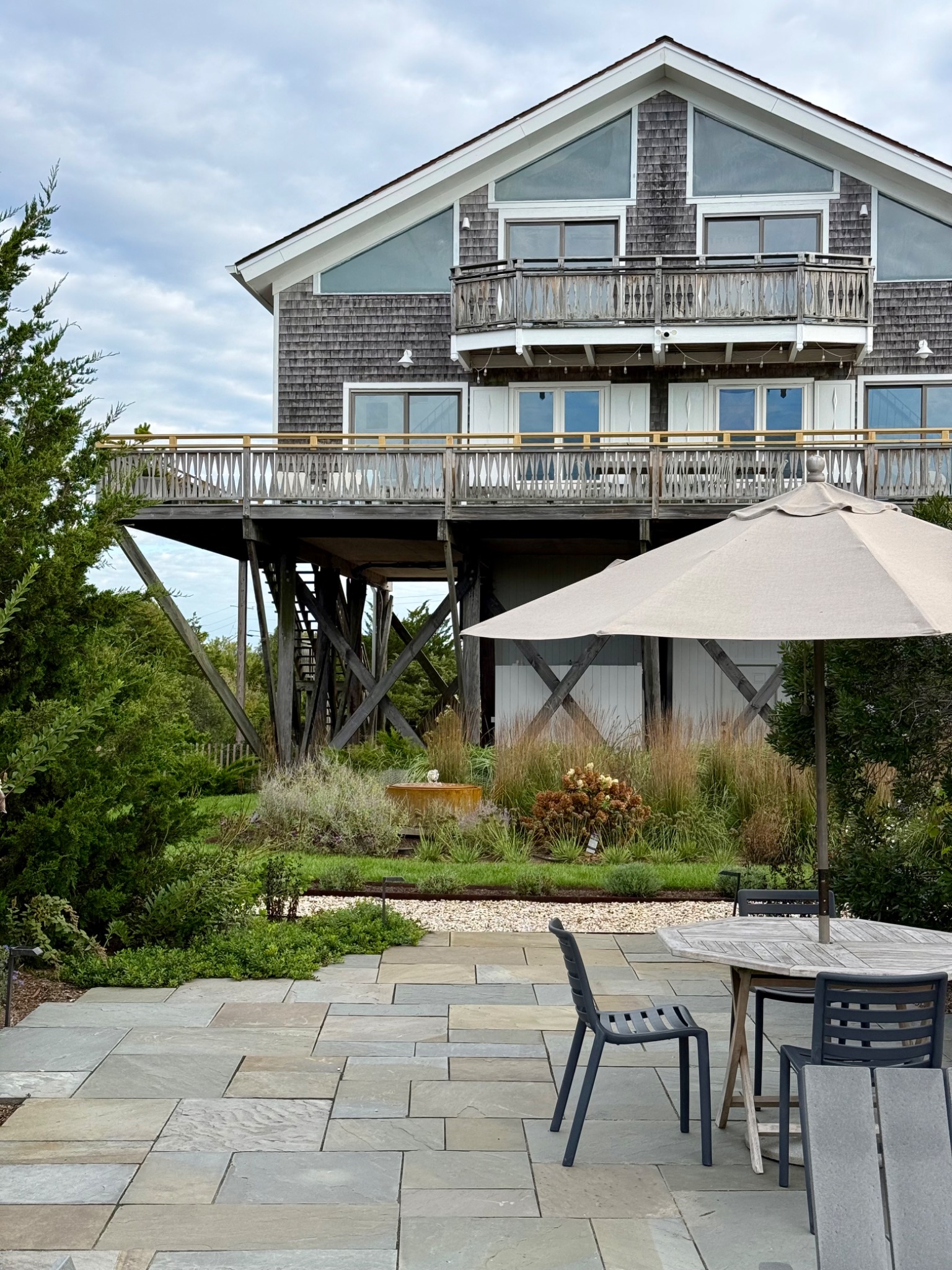 Bluestone patio and shaded dining beneath the Surf House balconies.